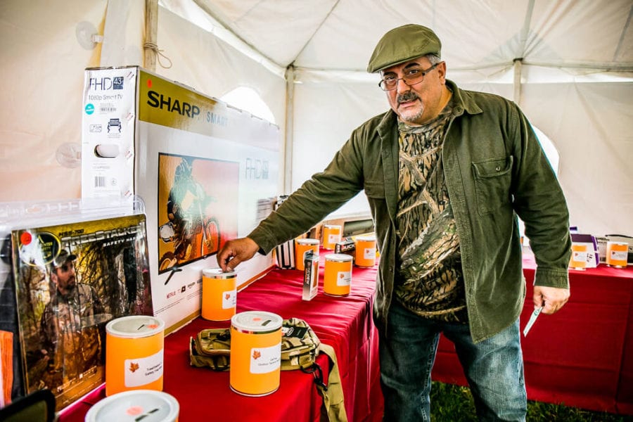 Man placing donation into collection tin