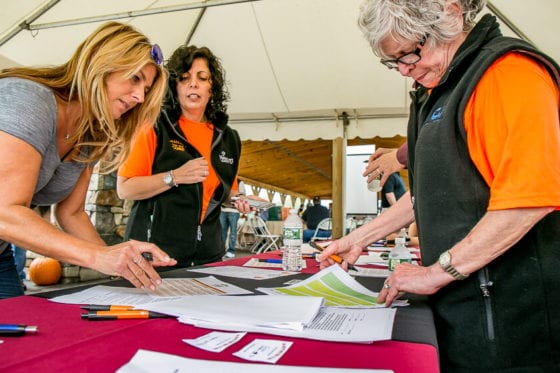 Volunteers reviewing registration forms at event