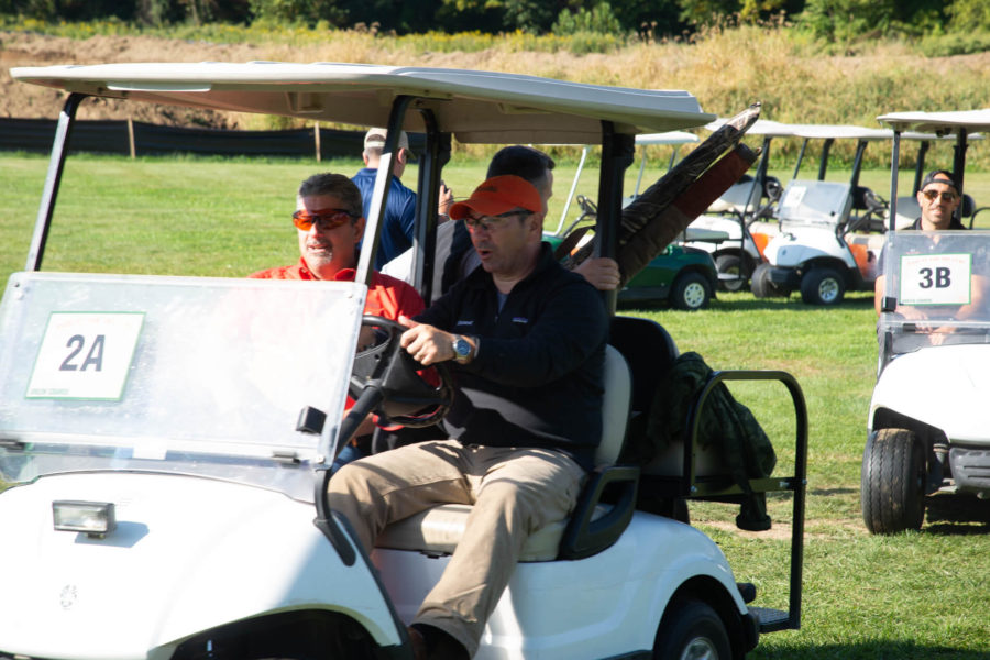 Two men in golf cart on course