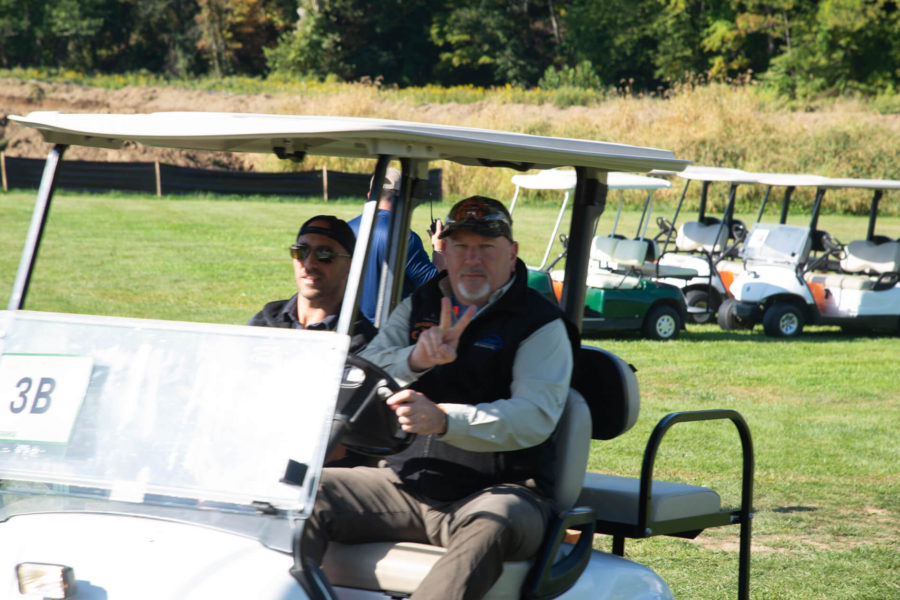 Two men in golf cart on course