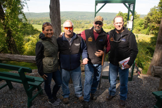 Four people posing on scenic overlook