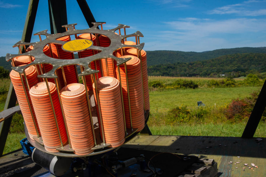 Stack of orange clay targets on skeet thrower