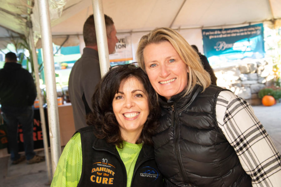 Two smiling women at outdoor charity event