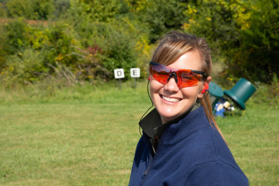 Woman with orange safety glasses at shooting range