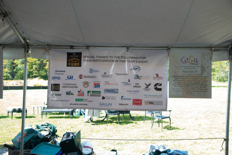 Sponsor banner hanging inside outdoor event tent
