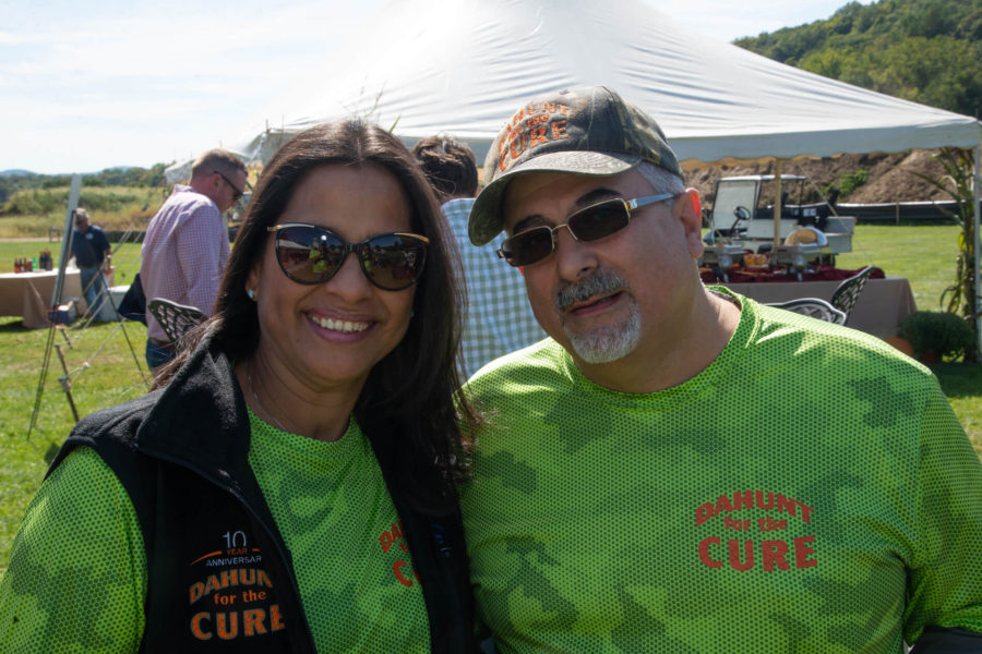 Smiling volunteers in green CURE shirts