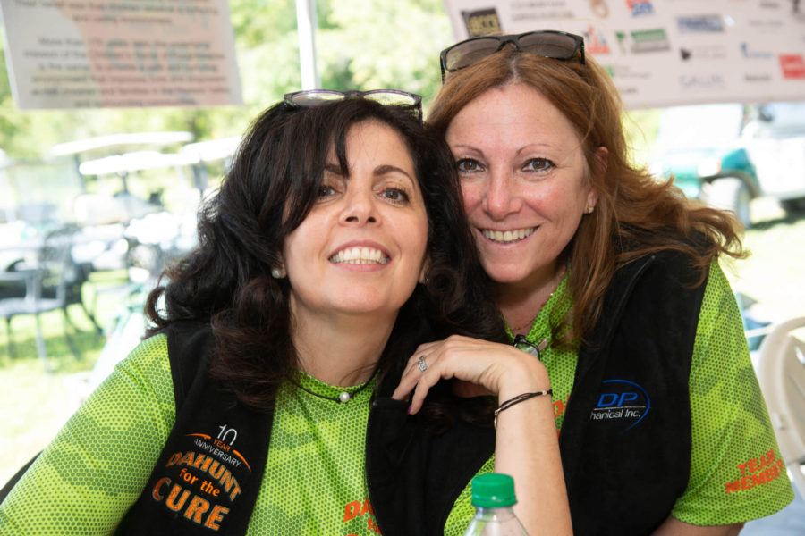 Two women smiling at outdoor charity event
