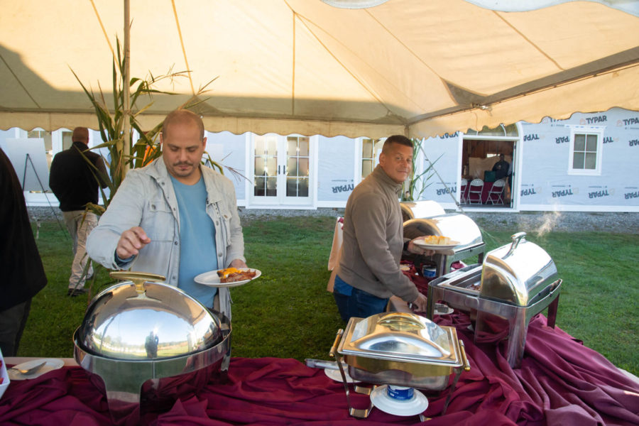 Outdoor buffet with chafing dishes and guests