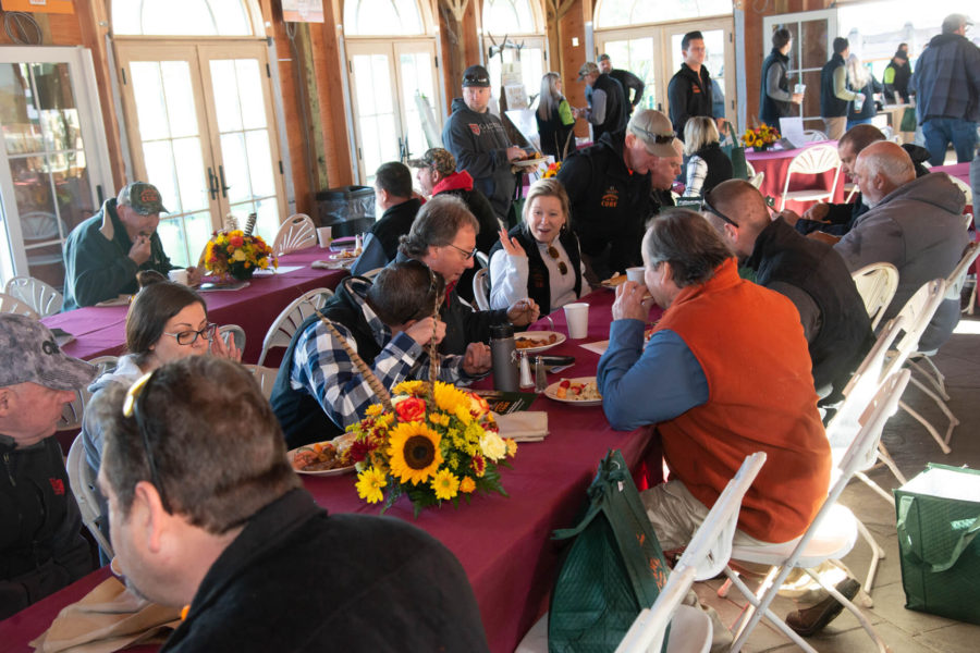 Community meal in rustic hall with sunflowers