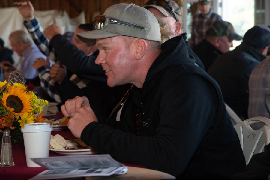Man in cap eating at communal table