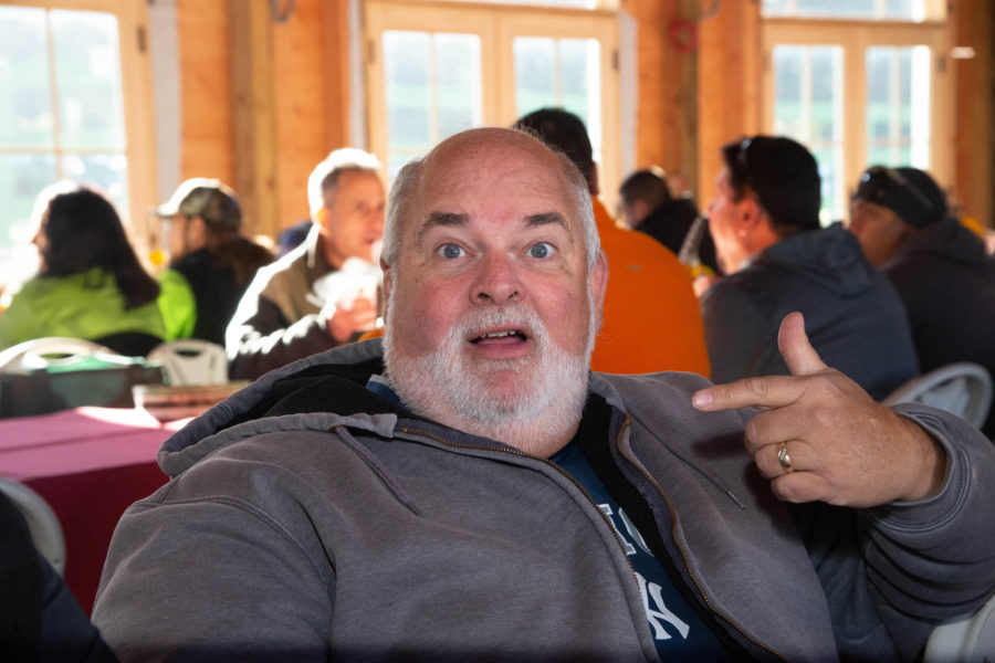 Surprised bearded man pointing at himself indoors