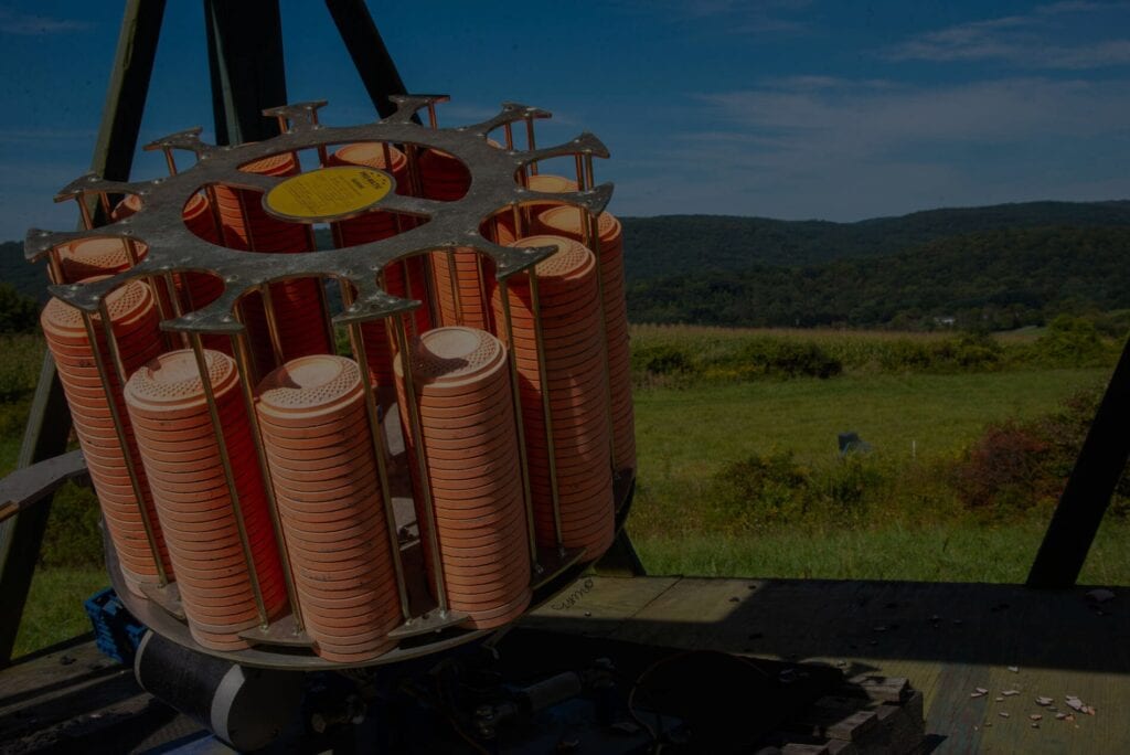 Orange clay targets stacked on skeet trap