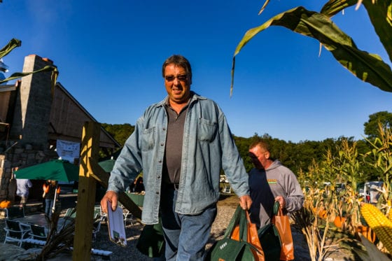 Man carrying bags at autumn pumpkin patch