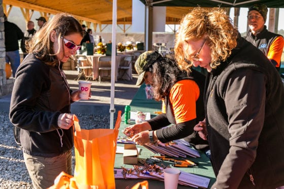 Attendees registering at outdoor event table