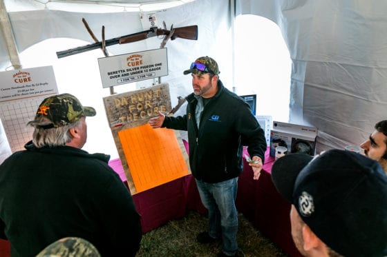 Man explaining items at fundraising booth