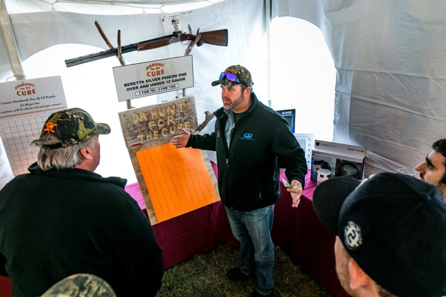 Man explaining items at fundraising booth