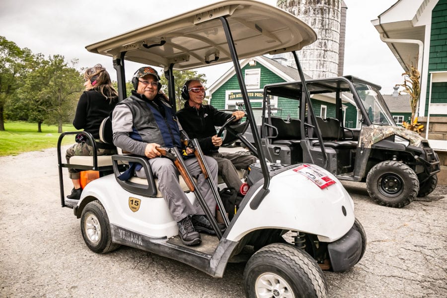 Two people smiling in a white golf cart