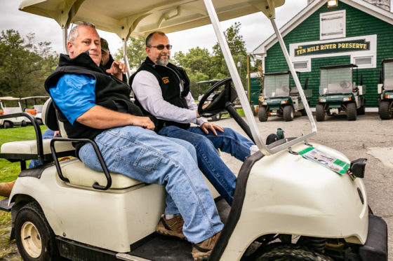 Two men in golf cart at preserve