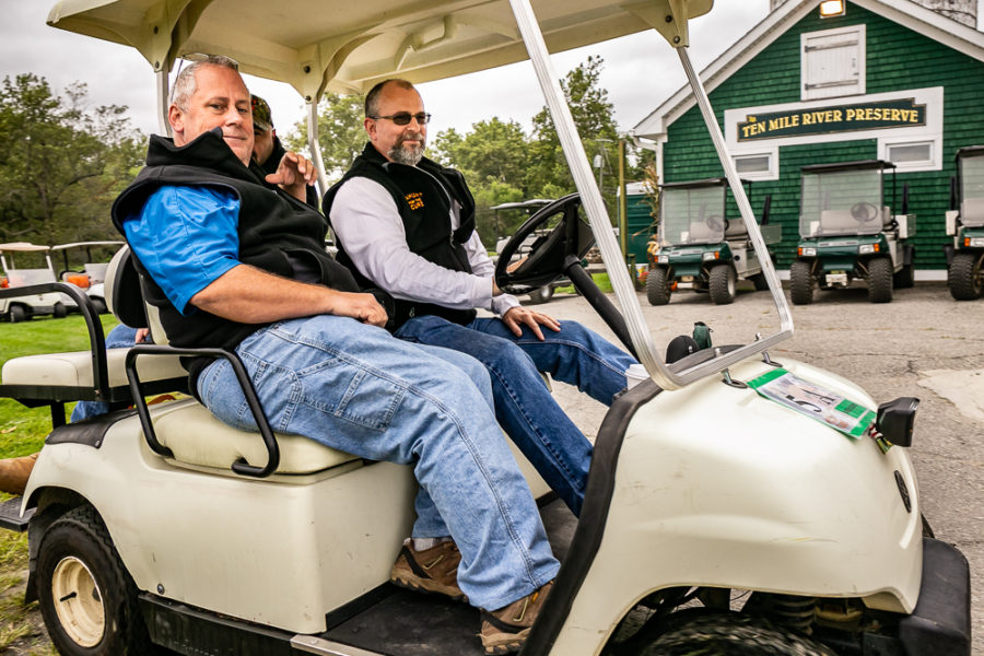 Two men in golf cart at preserve