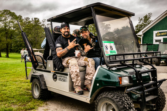 Two men smiling in golf cart on course
