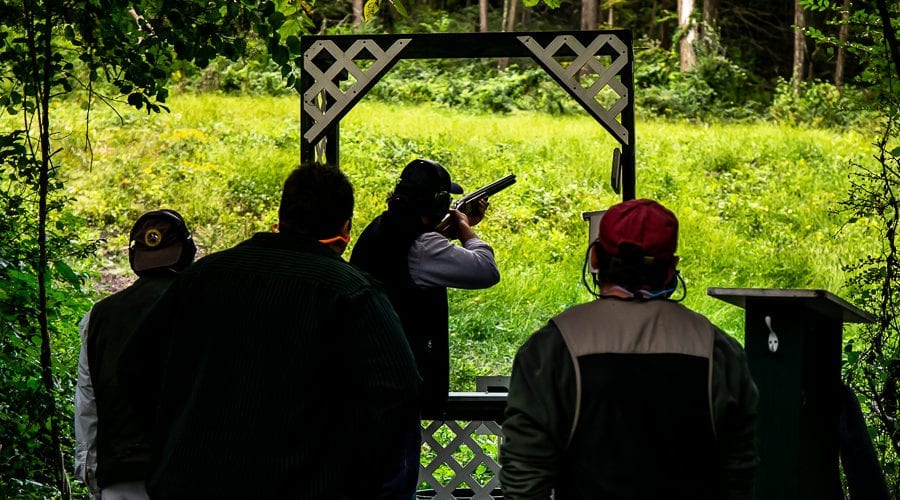 People skeet shooting at an outdoor range