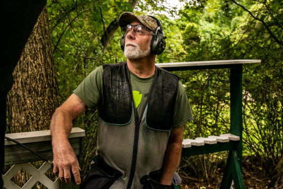 Older man wearing ear protection at shooting range