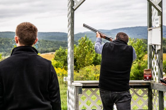 Two men clay pigeon shooting outdoors