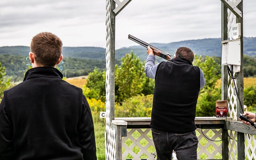 Two men clay pigeon shooting outdoors