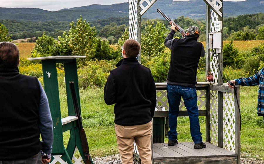 Group participating in outdoor clay pigeon shooting