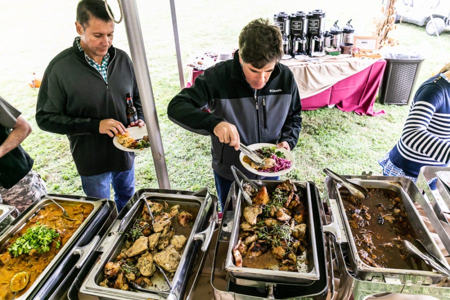 Outdoor buffet with roasted meats and sides