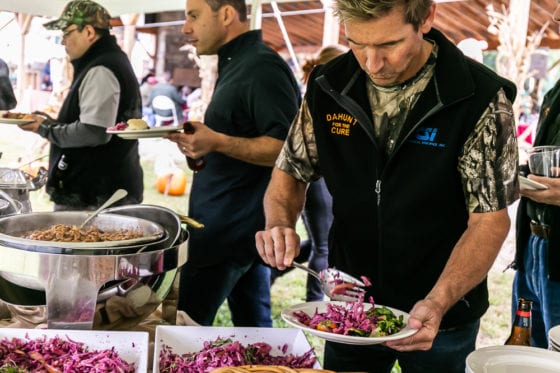 Man serving purple coleslaw at buffet