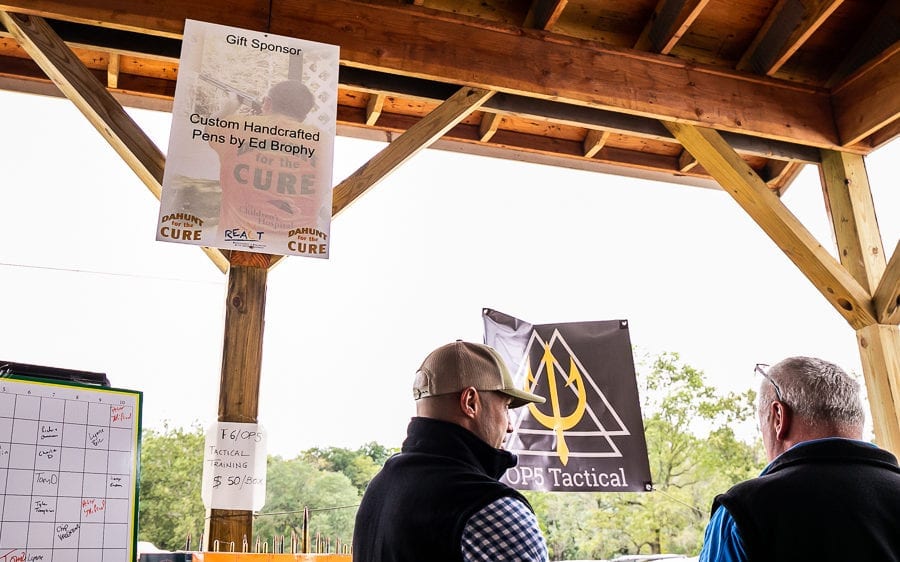 Two men under wooden pavilion with banners