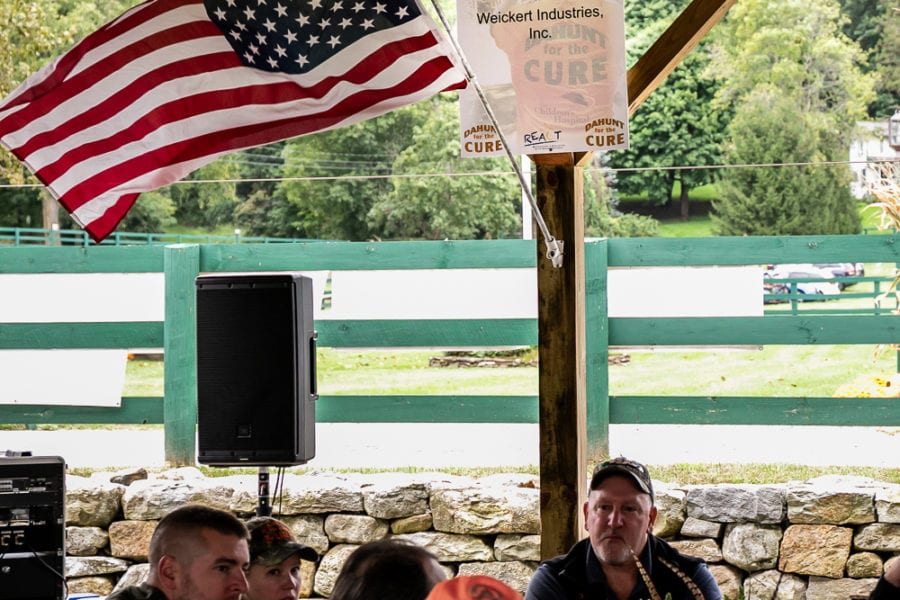 Outdoor event under pavilion with American flag