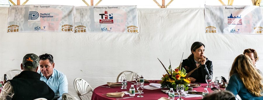 Attendees seated at banquet tables with centerpiece