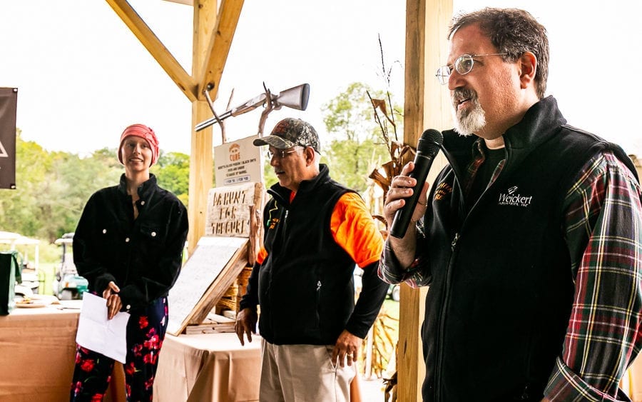 Man speaking into microphone at outdoor event