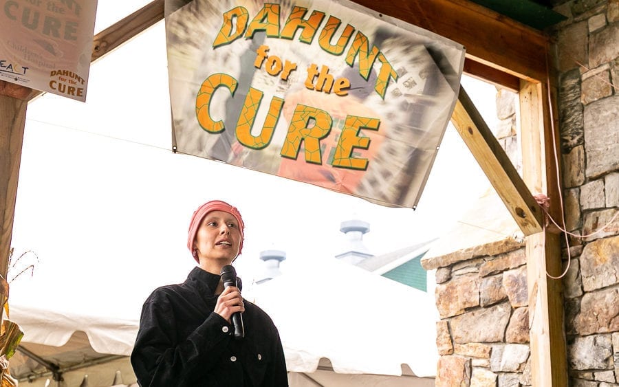 Person speaking at "Dahun for the Cure" banner
