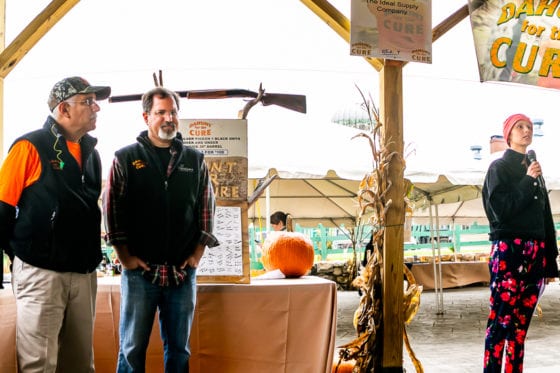 Woman speaking at outdoor autumn charity fundraiser
