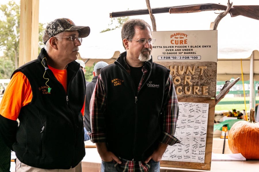 Two men at charity raffle table