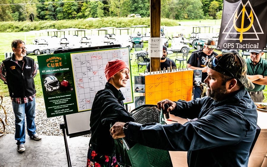 People at outdoor shooting range with whiteboards