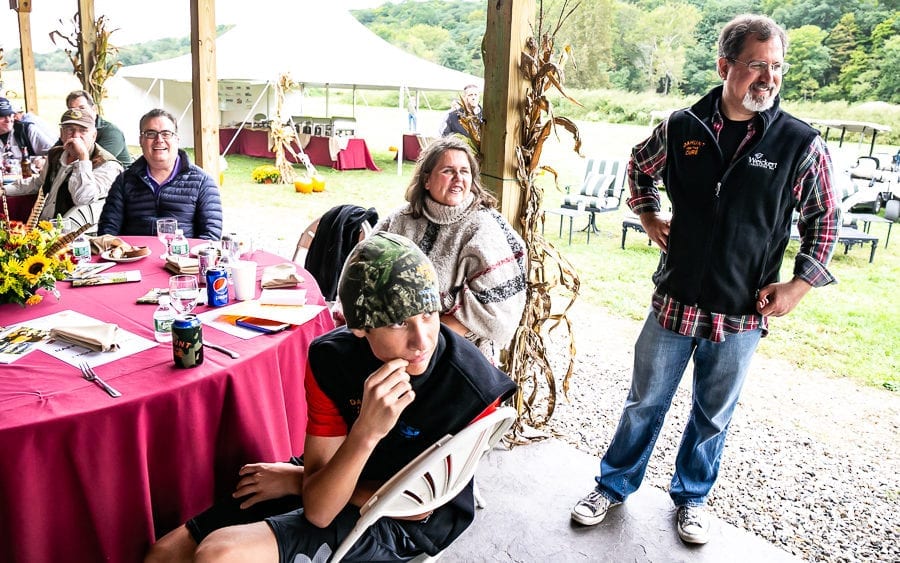 Group dining at outdoor tented event