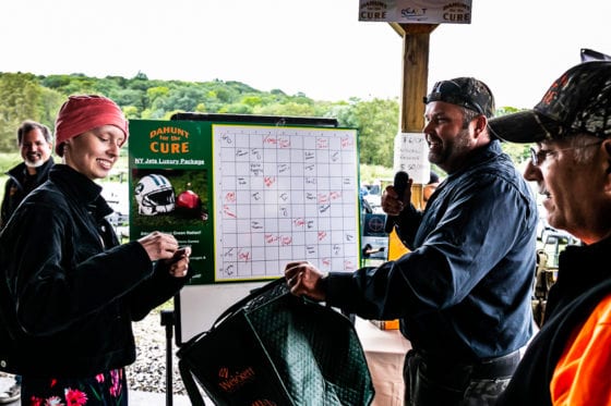 People marking board at outdoor community event