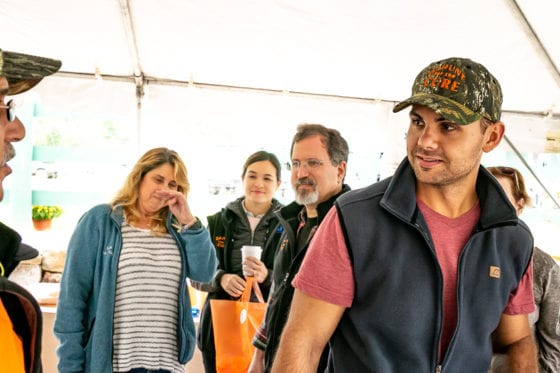 Group of people chatting under a tent