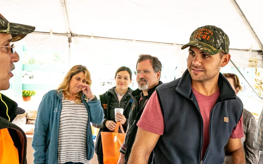 Group of people chatting under a tent