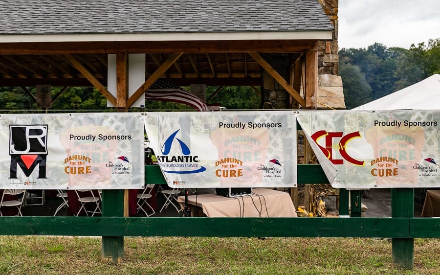Sponsor banners displayed on fence at pavilion