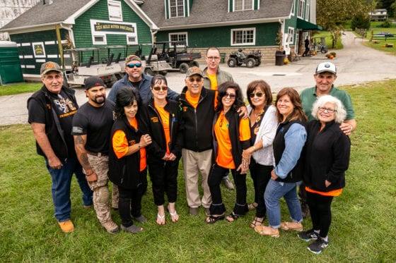 Group of smiling people in orange shirts