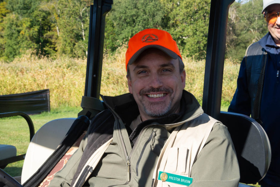 Smiling man in orange cap outdoors
