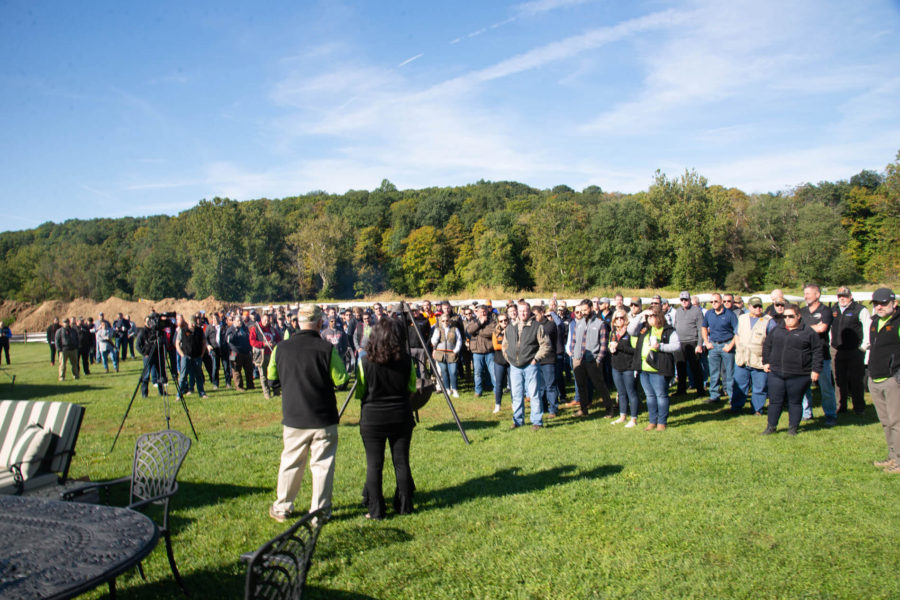 Large outdoor crowd gathered on grassy field