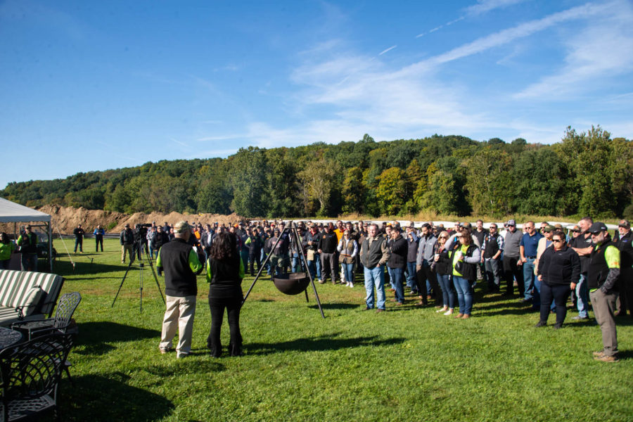 Large outdoor crowd gathered on grassy field