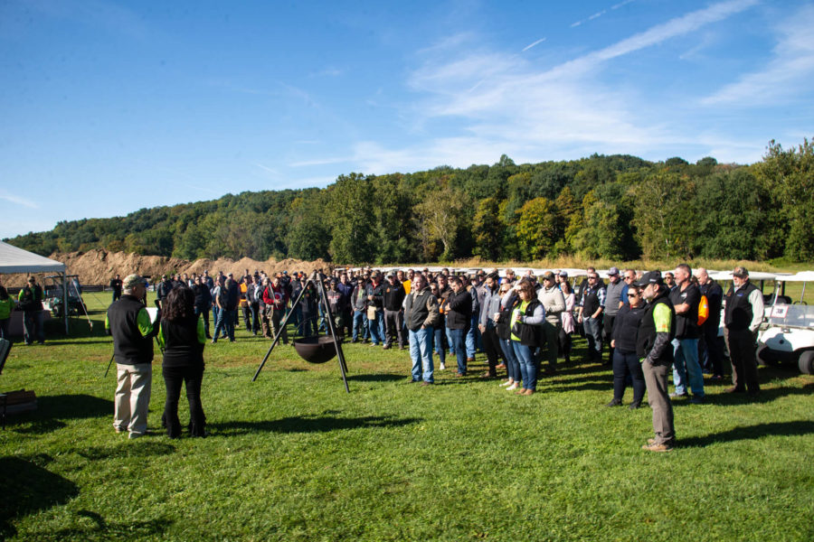 Large outdoor crowd gathered on grassy field