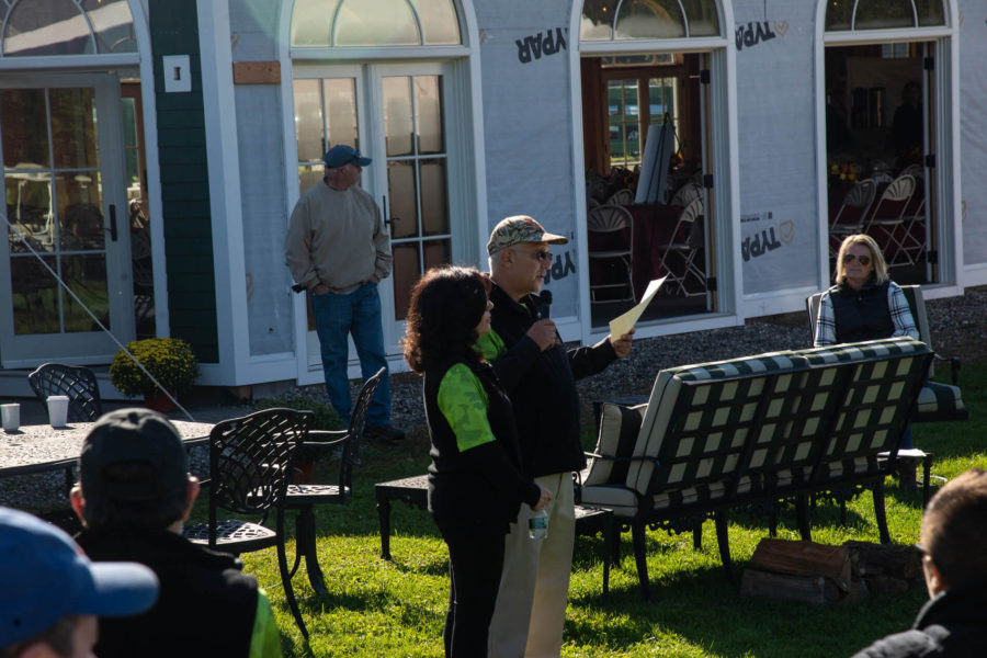Man speaking with microphone at outdoor event